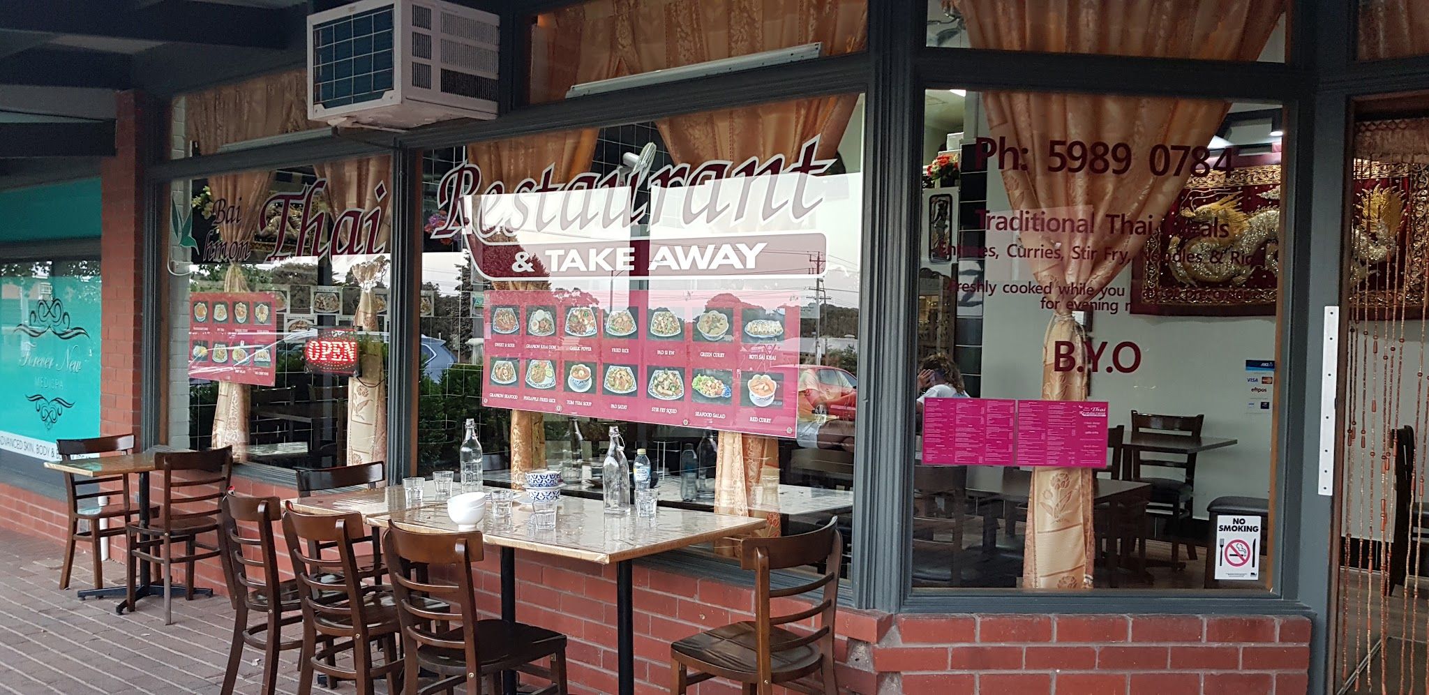 Baihmon Thai Restaurant exterior in daylight with outdoor tables and signage on Cook Street Flinders